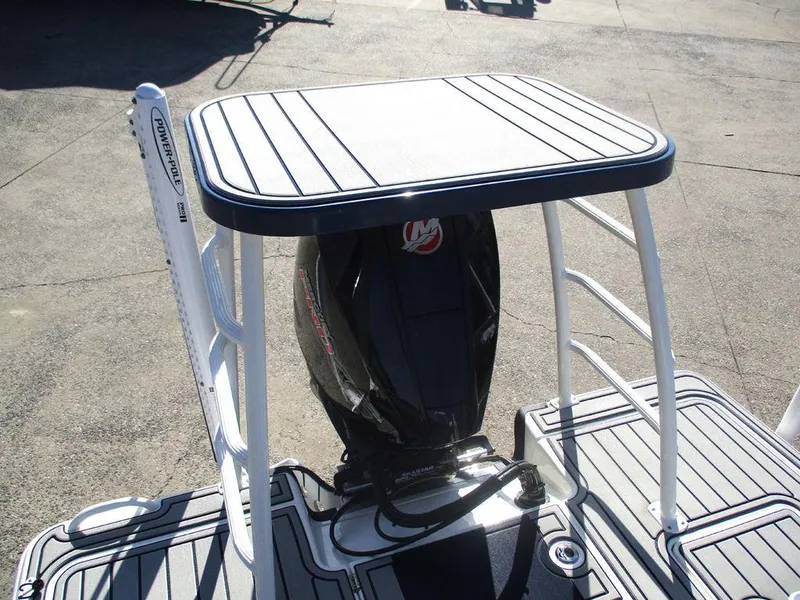 Slide: The Image of 2025 Mako 18 Pro Skiff Patriot Edition with outboard motor and sturdy deck design. - 11