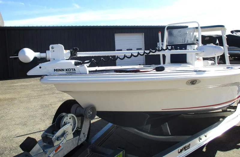 Slide: The Image of 2025 Mako 18 Pro Skiff Patriot Edition on trailer with Minn Kota trolling motor. - 7