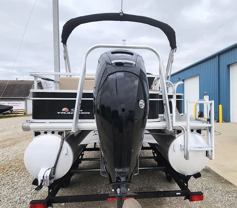 Slide: The Image of 2018 Sun Tracker Fishin' Barge 20 DLX pontoon boat with outboard motor, docked outdoors. - 5