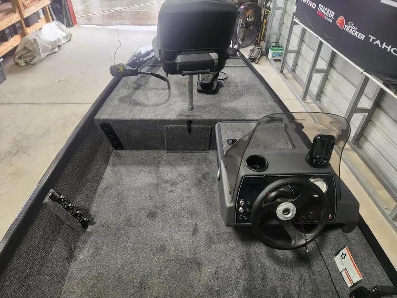 Slide: The Image of 2025 Tracker BASS TRACKER® Classic XL boat interior with steering console and seating. - 4