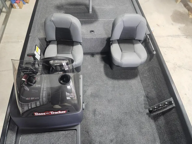 Slide: The Image of 2025 Tracker BASS TRACKER® Classic XL boat interior with two gray seats and steering console. - 7