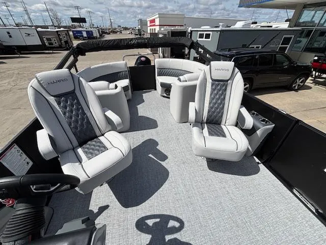 Slide: The Image of 2025 Harris Sunliner 230 boat interior with luxurious seating and modern design. - 13