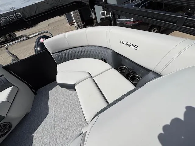 Slide: The Image of 2025 Harris Sunliner 230 boat interior with plush seating and cup holders. - 17