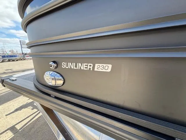 Slide: The Image of 2025 Harris Sunliner 230 boat exterior with logo and sleek design. - 2