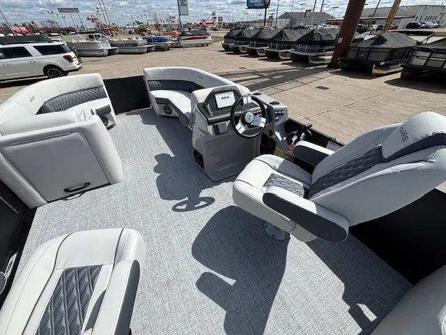 Slide: The Image of 2025 Harris Sunliner 230 pontoon boat interior with modern seating and steering console. - 22