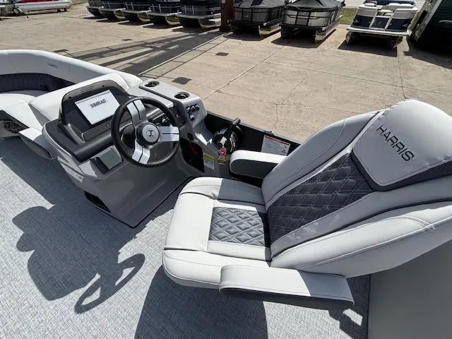 Slide: The Image of 2025 Harris Sunliner 230 boat interior with modern steering and luxurious seating. - 23