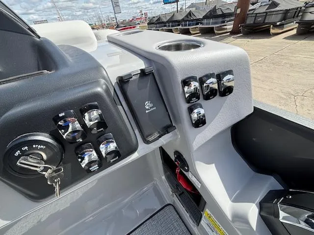 Slide: The Image of Control panel of 2025 Harris Sunliner 230 boat with switches and key ignition. - 25