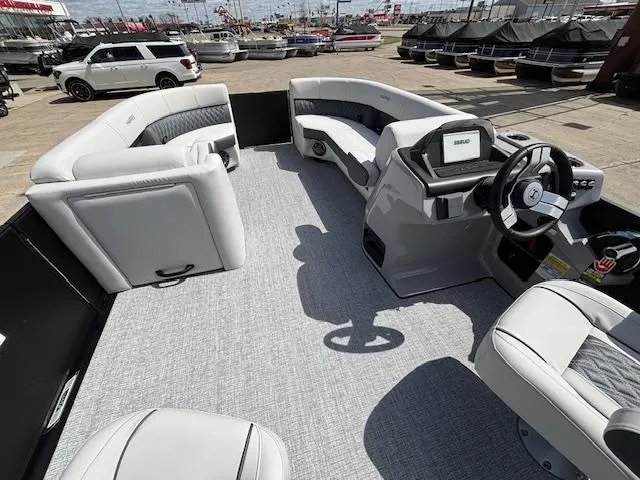 Slide: The Image of 2025 Harris Sunliner 230 pontoon boat interior with modern seating and steering console. - 28