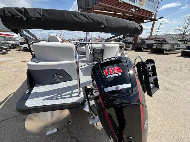 Slide: The Image of 2025 Harris Sunliner 230 pontoon boat with Mercury 115 engine, docked outdoors. - 5