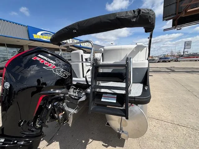 Slide: The Image of 2025 Harris Sunliner 230 pontoon boat with Mercury Pro XS engine, docked outdoors. - 6