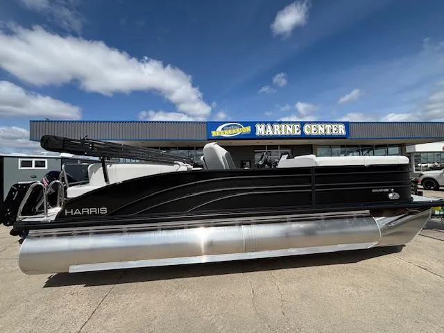 Slide: The Image of 2025 Harris Sunliner 230 pontoon boat displayed at a marine center under a blue sky. - 8