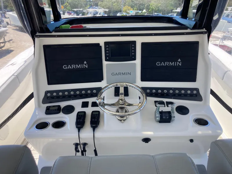 Slide: The Image of 2014 Insetta i45C boat dashboard with Garmin navigation displays and controls. - 10