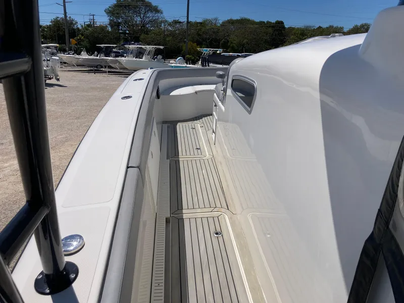 Slide: The Image of 2014 Insetta i45C boat deck, featuring sleek white design and spacious walkway. - 12