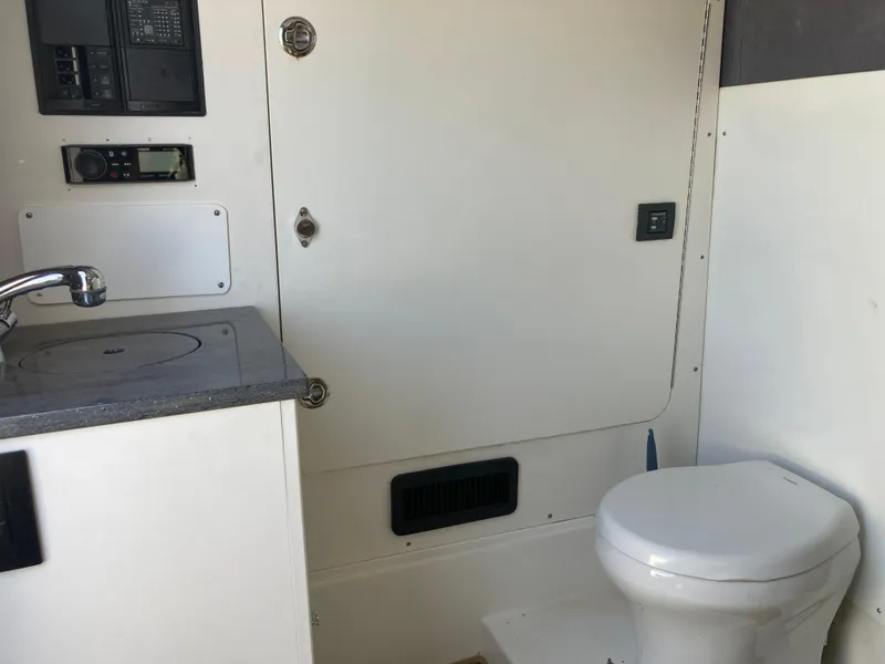 Slide: The Image of 2014 Insetta i45C boat bathroom with sink, toilet, and control panel. - 16