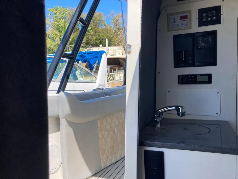 Slide: The Image of Interior view of 2014 Insetta i45C boat, featuring a compact sink and control panel. - 17