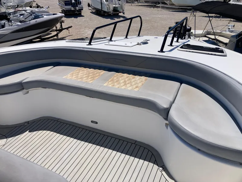 Slide: The Image of 2014 Insetta i45C boat interior with cushioned seating and deck view. - 20