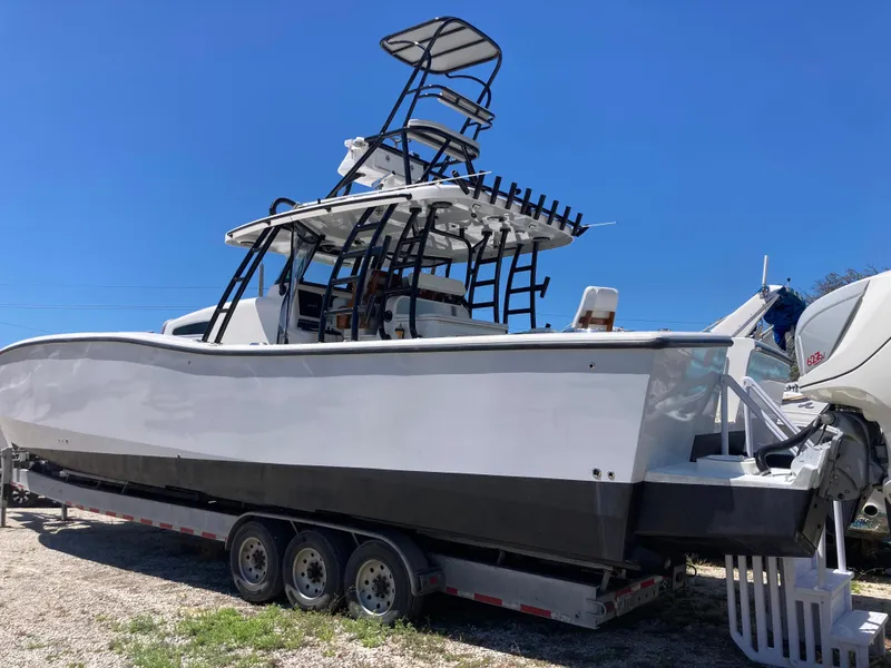 Slide: The Image of 2014 Insetta i45C boat on trailer under clear blue sky. - 3