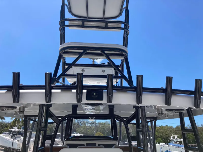 Slide: The Image of 2014 Insetta i45C boat with tower and rod holders under clear blue sky. - 6