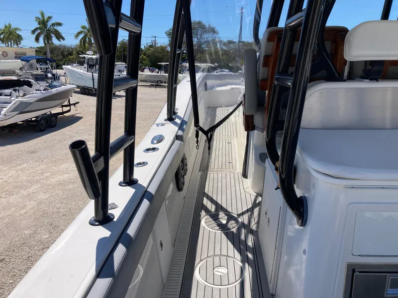 Slide: The Image of 2014 Insetta i45C boat interior with seating and railing, parked outdoors. - 7