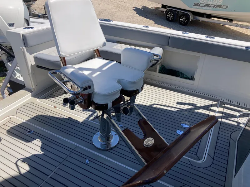Slide: The Image of Fishing chair on 2014 Insetta i45C boat deck, featuring white upholstery and sturdy metal frame. - 9
