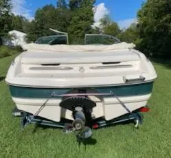 Slide: The Image of Rear view of a 2000 Chaparral 196 SSi boat on grass, under a clear sky. - 10