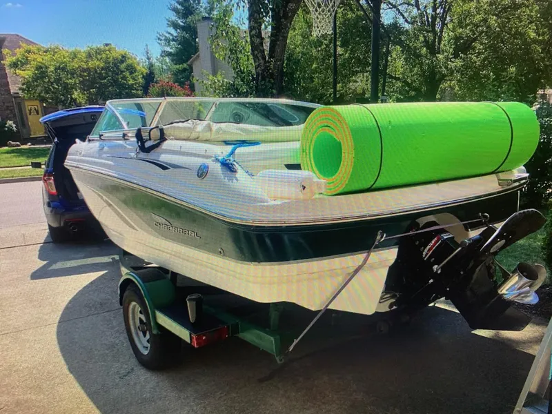 Slide: The Image of Chaparral 196 SSi boat from 2000 on trailer with green mat, parked in driveway. - 6