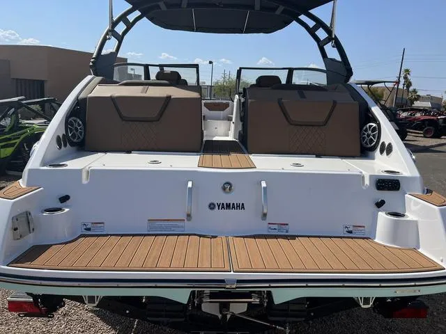Slide: The Image of 2024 Yamaha Boats 222SD, rear view, showcasing spacious deck and seating area. - 4
