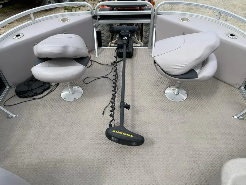 Slide: The Image of 2014 Grand Island 2085 QF pontoon boat interior with two swivel seats and trolling motor. - 15