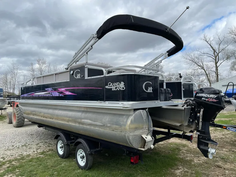Slide: The Image of 2014 Grand Island 2085 QF pontoon boat on trailer, under cloudy sky. - 2