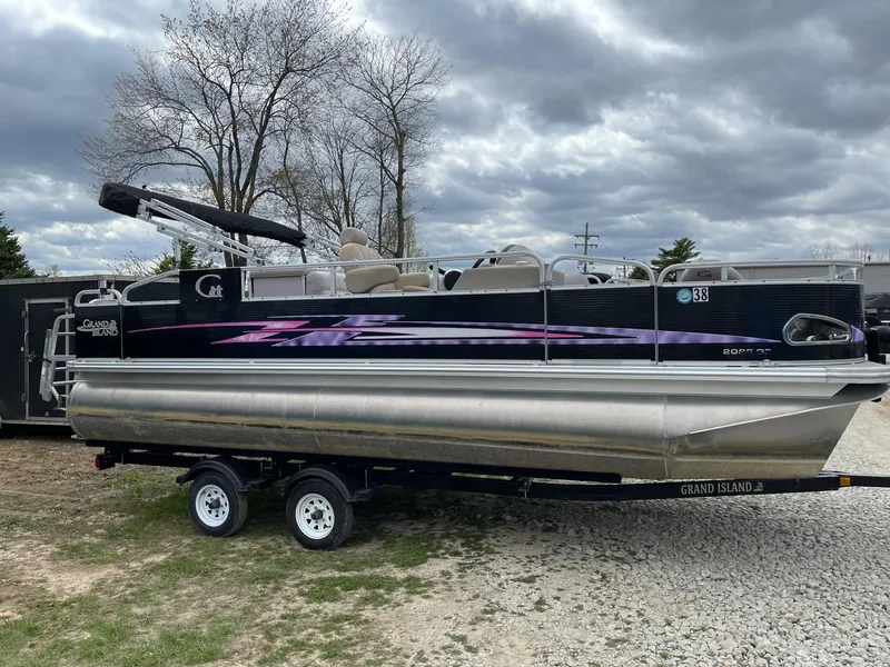 Slide: The Image of 2014 Grand Island 2085 QF pontoon boat on trailer, under cloudy sky. - 4