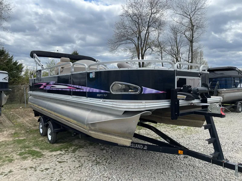 Slide: The Image of 2014 Grand Island 2085 QF pontoon boat on trailer, parked outdoors under cloudy sky. - 5