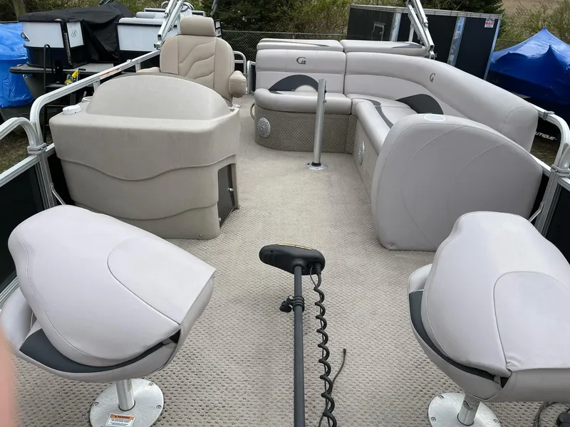Slide: The Image of 2014 Grand Island 2085 QF pontoon boat interior with beige seating and carpeted floor. - 6