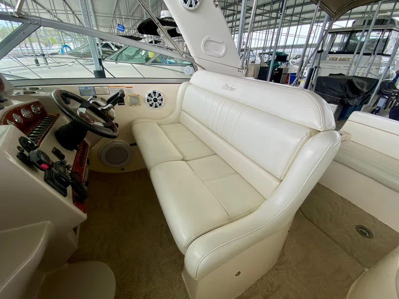 Slide: The Image of 2006 Rinker 360 Fiesta Vee boat interior with white leather seating and steering controls. - 10