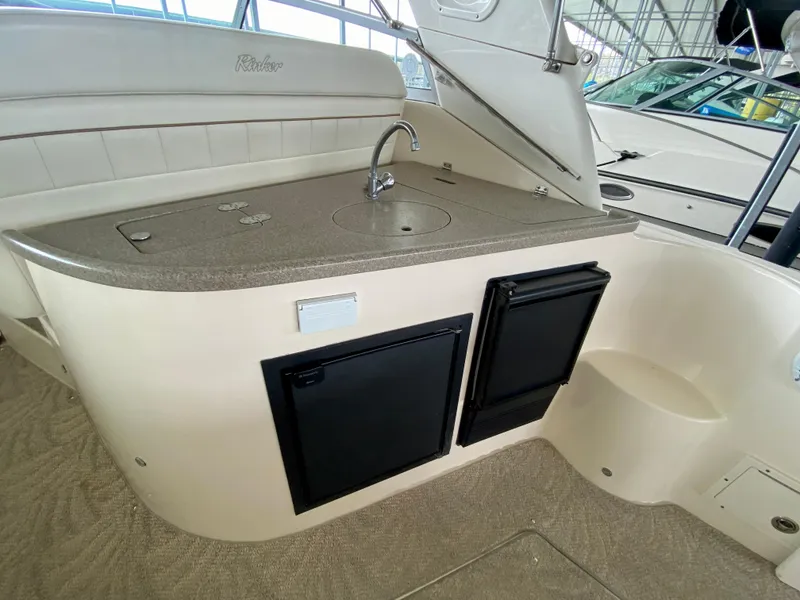 Slide: The Image of 2006 Rinker 360 Fiesta Vee boat interior with kitchenette and sink. - 11
