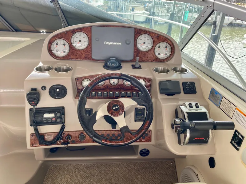 Slide: The Image of Helm of 2006 Rinker 360 Fiesta Vee with Raymarine navigation system and classic wood accents. - 13