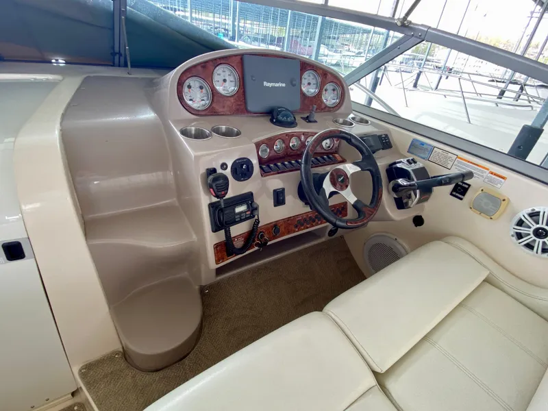 Slide: The Image of 2006 Rinker 360 Fiesta Vee boat dashboard with steering wheel and control panel. - 14