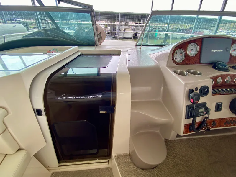 Slide: The Image of 2006 Rinker 360 Fiesta Vee boat interior with control panel and cabin door. - 15