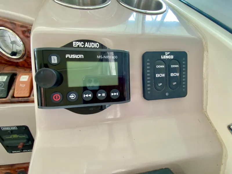 Slide: The Image of Control panel of a 2006 Rinker 360 Fiesta Vee with audio and trim controls. - 17