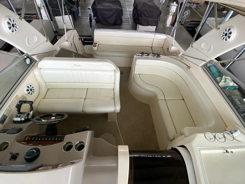 Slide: The Image of 2006 Rinker 360 Fiesta Vee boat interior with white seating and control panel. - 21