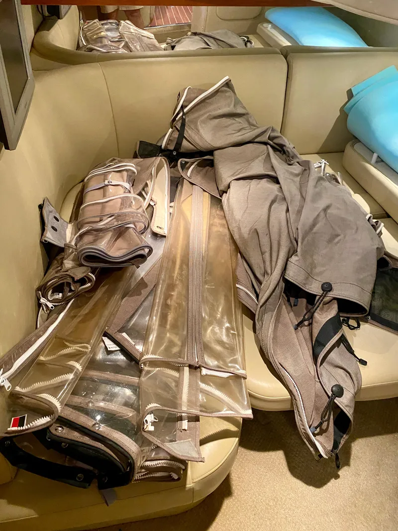 Slide: The Image of Canvas and plastic boat covers inside a 2006 Rinker 360 Fiesta Vee cabin. - 29