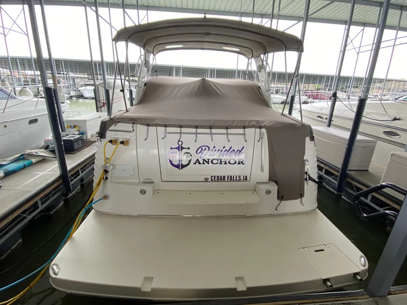 Slide: The Image of 2006 Rinker 360 Fiesta Vee boat docked with covered deck in marina. - 3
