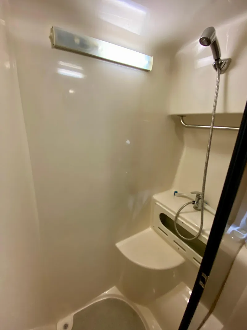 Slide: The Image of 2006 Rinker 360 Fiesta Vee boat shower with handheld showerhead and built-in seat. - 34