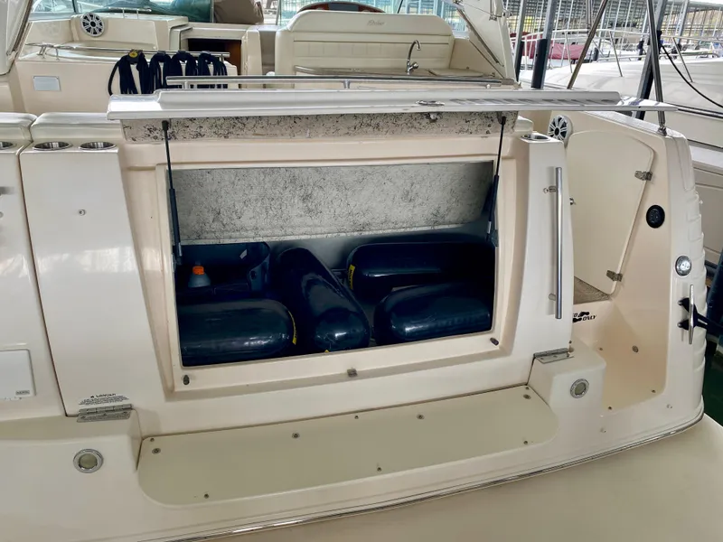 Slide: The Image of 2006 Rinker 360 Fiesta Vee boat storage compartment with inflatable fenders inside. - 38