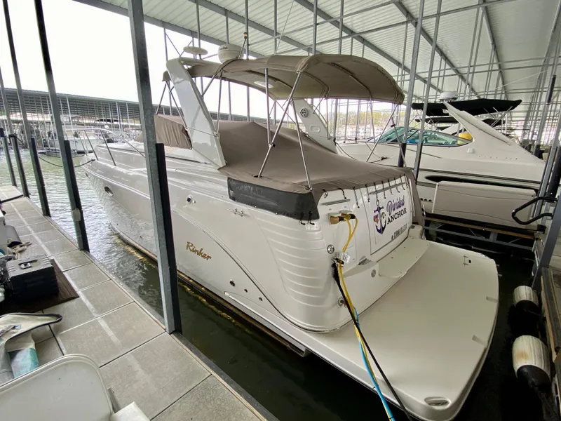 Slide: The Image of 2006 Rinker 360 Fiesta Vee boat docked in a covered marina. - 4