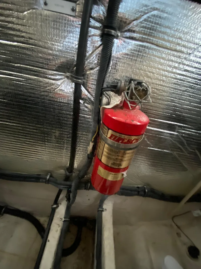Slide: The Image of 2006 Rinker 360 Fiesta Vee engine compartment with fire extinguisher and insulation. - 42