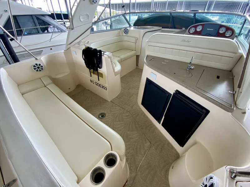 Slide: The Image of 2006 Rinker 360 Fiesta Vee boat interior with seating, sink, and storage. - 6