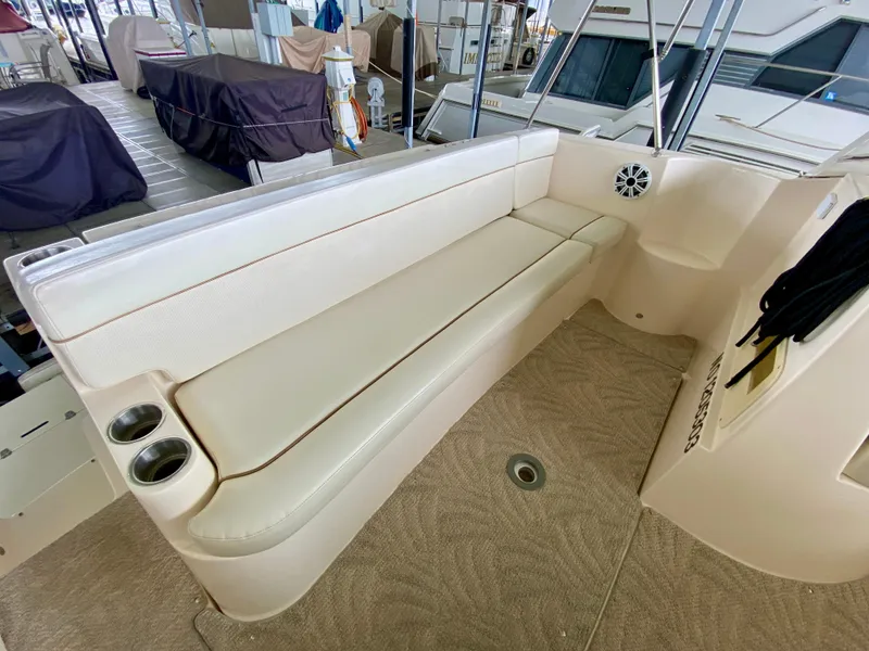 Slide: The Image of 2006 Rinker 360 Fiesta Vee boat interior with beige seating and cup holders. - 7