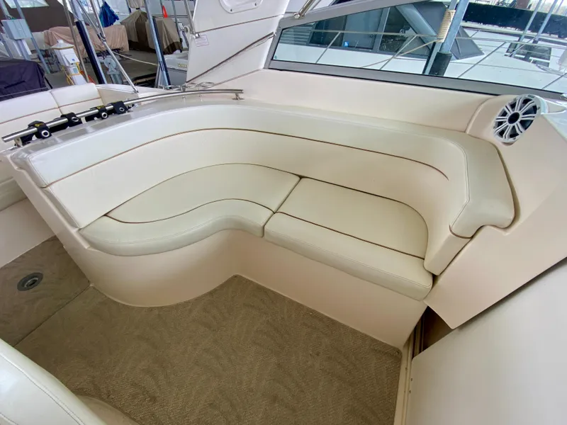 Slide: The Image of 2006 Rinker 360 Fiesta Vee boat interior with white leather seating. - 9
