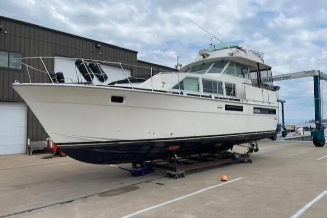 Slide: The Image of 1977 Bertram 42 Motor Yacht on dry dock, marina background. - 0