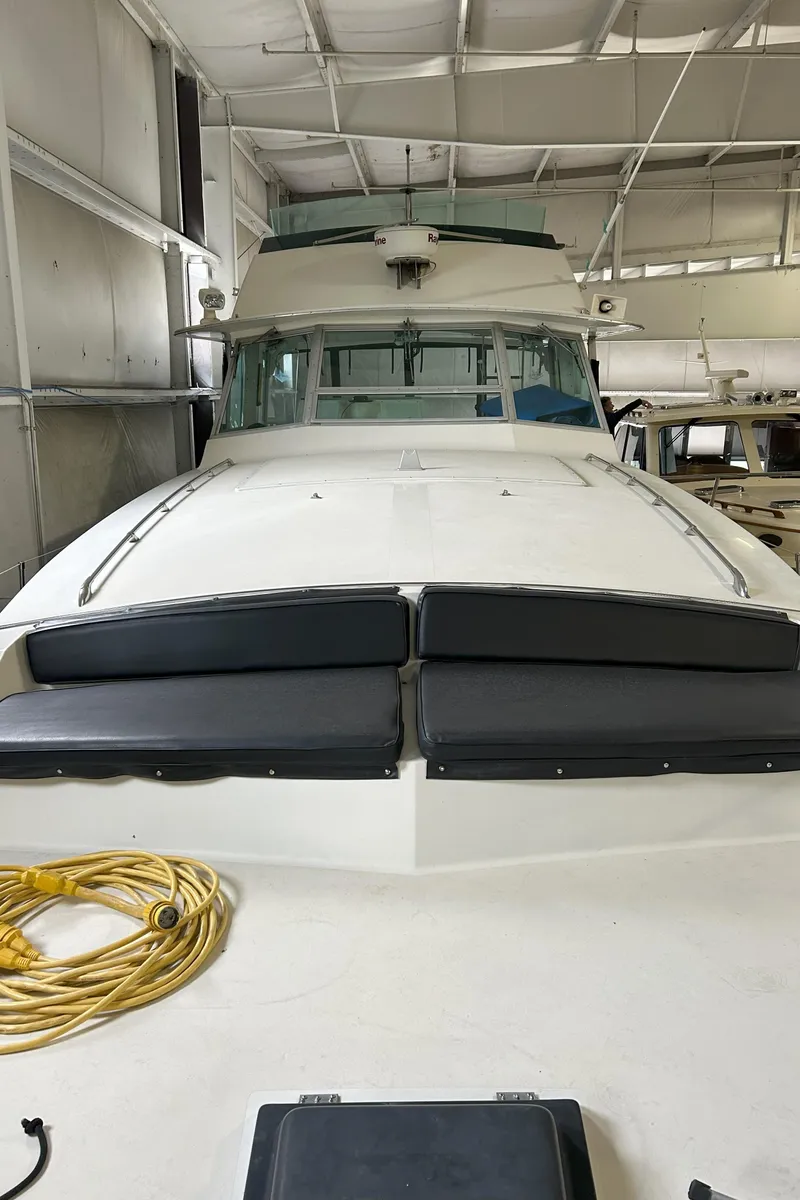 Slide: The Image of 1977 Bertram 42 Motor Yacht in storage, showcasing front deck and cabin. - 10